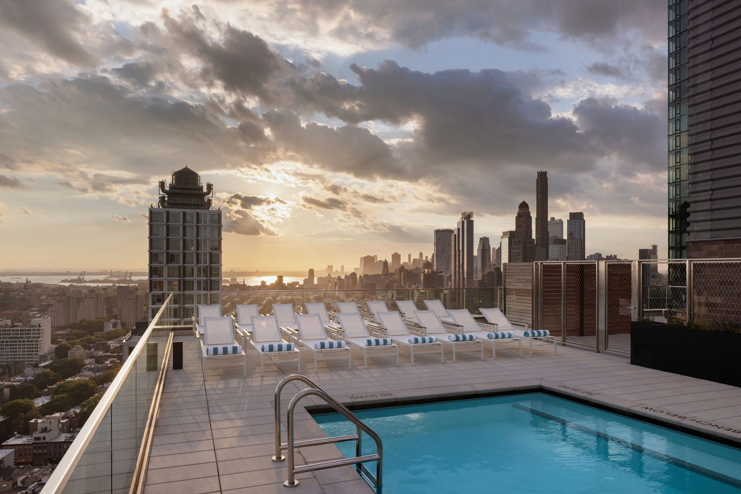 Plank Road rooftop amenity space with swimming pool at sunset